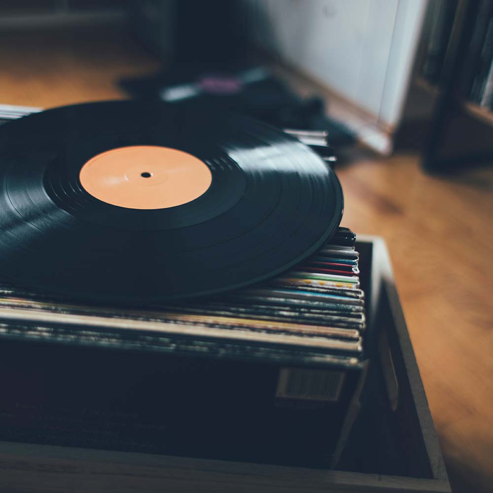 Close-up of Vinyl Record on top of Box of Records